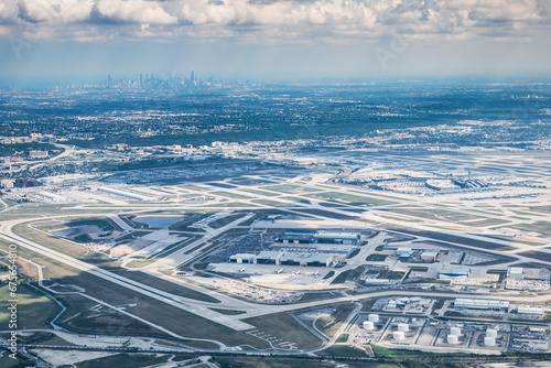 Aerial view of an airport with the city skyline in the background.