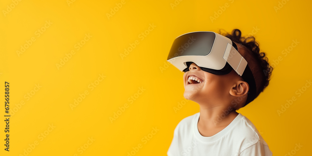 Young boy getting experience using VR headset glasses isolated on a yellow background with copy space Young boy getting experience using VR headset glasses isolated on a yellow background with copy space