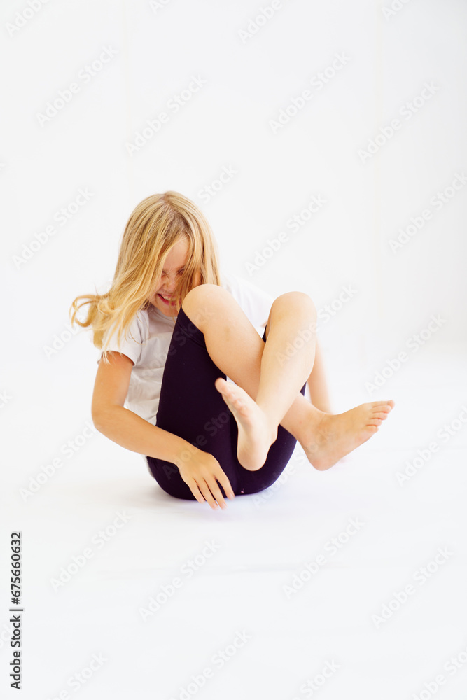 Cheerful teenage girl in white t-shirt and black breeches on white background Cheerful teenage girl in white t-shirt and black breeches on white background