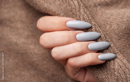 Woman s hand with grey nail polish