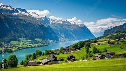 Idyllic Swiss nature landscape - green meadows surrounded by Alps mountains. Scenic lake Brienz, Iseltwald village