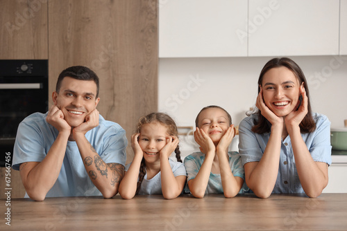 Happy family at table in kitchen