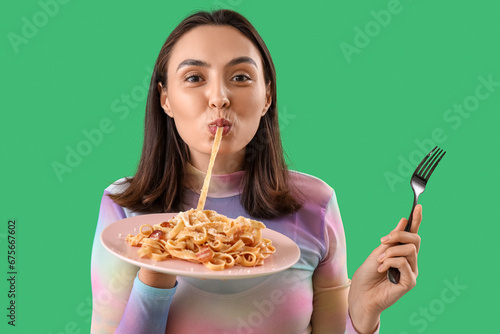 Young woman eating tasty pa...