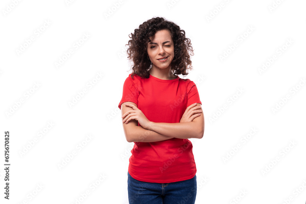 corporate clothing concept. young smiling curly brunette woman in red t-shirt on white background with copy space corporate clothing concept. young smiling curly brunette woman in red t-shirt on white background with copy space