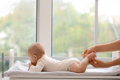 Mother massaging her baby's...
