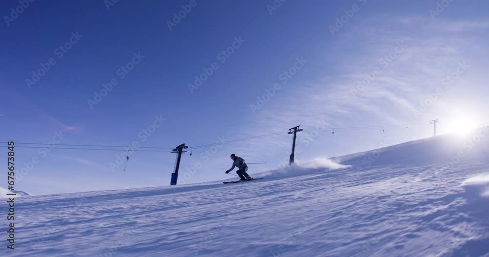 Experienced male skier skiing on slopes on a ski center. Recorded at 120 fps. Experienced male skier skiing on slopes on a ski center. Recorded at 120 fps.