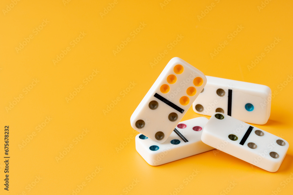 Domino tiles on yellow background studio shot Domino tiles on yellow background studio shot