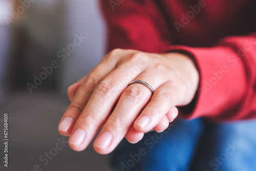 Closeup image of a woman hand wearing silver ring on her finger