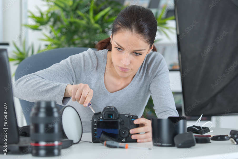 female photographer assembling her camera female photographer assembling her camera
