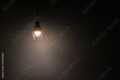 Light bulb warm light shade on dark background, concept of creativity and innovation. photo