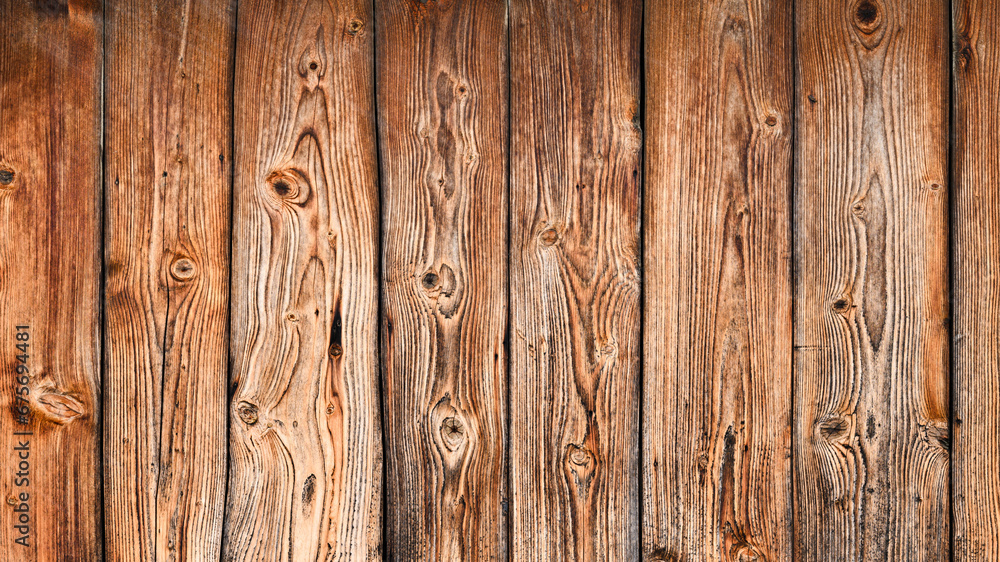 The background of the wall with the texture of boards painted with orange paint