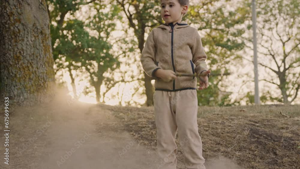 Little boy playing with big branch and having fun in forest on early spring day. Activity for children. Outdoor recreation for family with kids Little boy playing with big branch and having fun in forest on early spring day. Activity for children. Outdoor recreation for family with kids