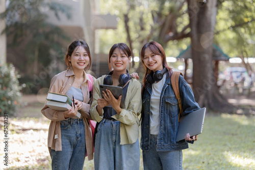 university students using a digital tablet while walking to next class