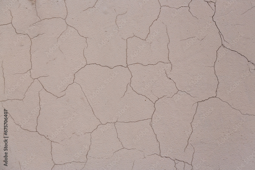 Old wall with cracked plaster. Weathered rough surface. Vintage texture is perfect for background and design. Old wall with cracked plaster. Weathered rough surface. Vintage texture is perfect for background and design.