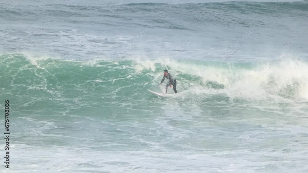 Surfer on a perfect wave, attempting to jump over it but giving up. Surfer on a perfect wave, attempting to jump over it but giving up.