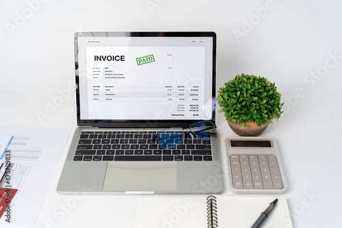 Close-up difference invoices and bills, document and paperwork. Digital Tax E Invoice Online Software On Laptop Screen.