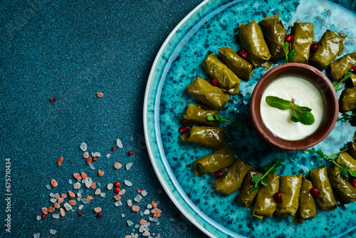 Traditional delicious Turkish foods: dolma (sarma) stuffed grape leaves rice. Close up. On a dark background.