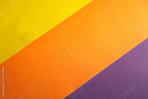 Photos background of multicolored paper parallel stripes of orange, yellow and purple c