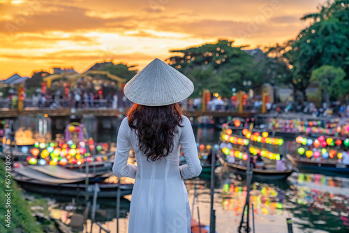 Asian woman wearing vietnam culture traditional at Hoi An ancient town, Vietnam. Hoi An is one of the most popular destinations in Vietnam  from Korea, Thailand, USA, Japan, China photo