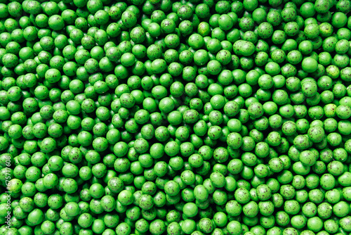 Closeup green dragee, chocolate covered nuts, sweet candy background