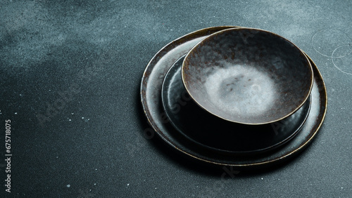 Empty gray plate (ceramic) set on a dark gray background. Free space for text. Top view.