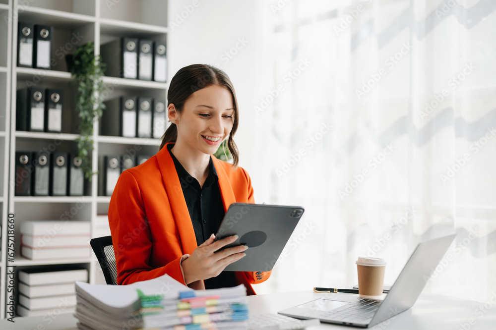 Business woman using tablet and laptop for doing math finance on an office Business woman using tablet and laptop for doing math finance on an office