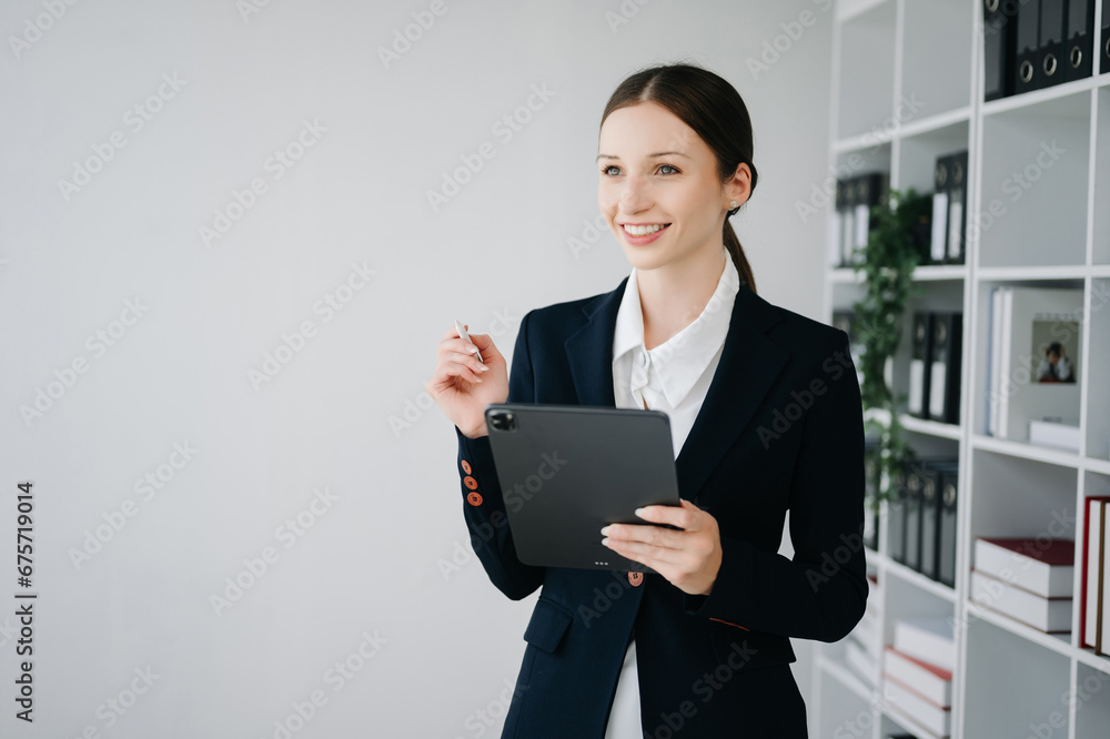 Business woman using tablet and laptop for doing math finance on an office Business woman using tablet and laptop for doing math finance on an office