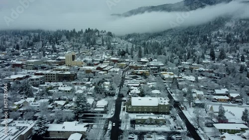 Ashland, Oregon, USA, Winter 2023. Downtown. On a rare snow day moving West to East along Main Street. The downtown area has Ashland Springs Hotel on the left, and back to the right is Lithia Park. photo