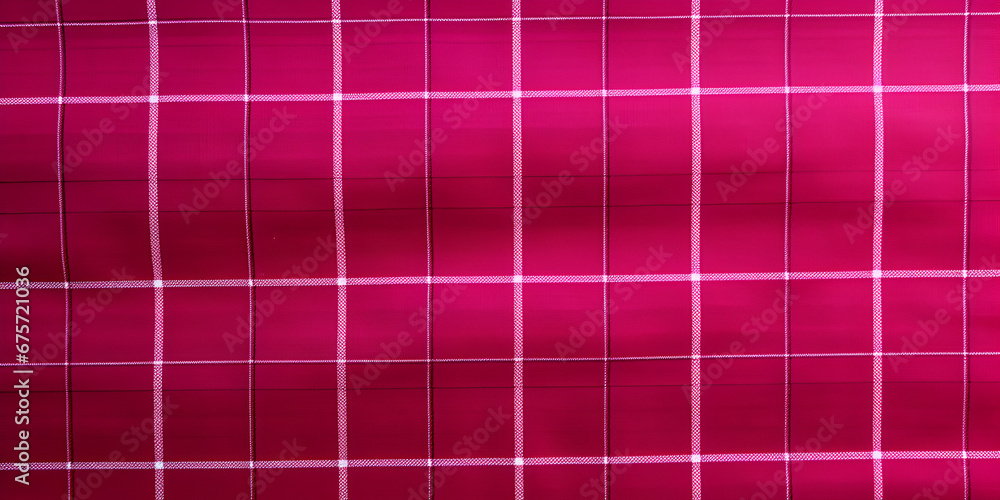 Pink and white plaid textured fabric background Pink and white plaid textured fabric background