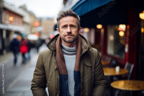 Handsome middle-aged man walking down a street in London.
