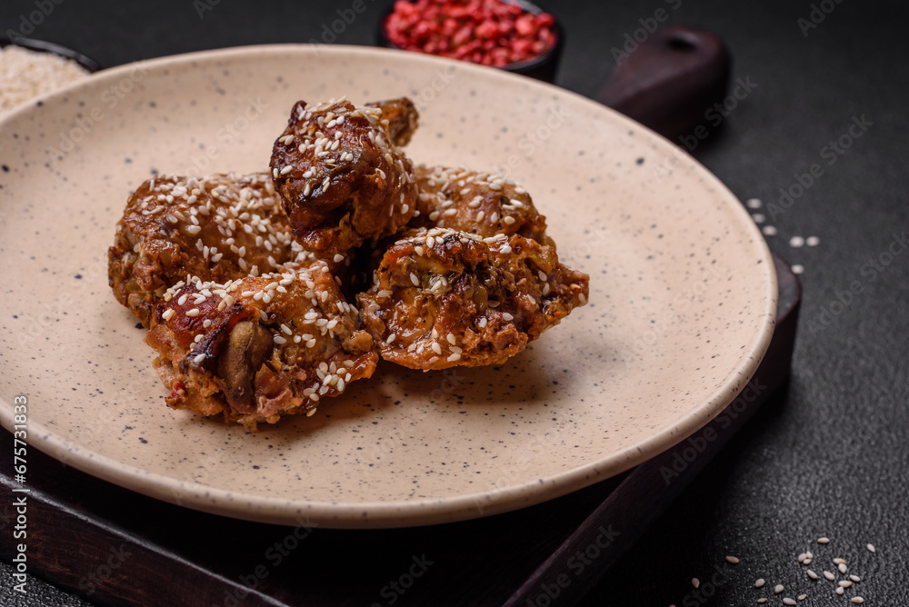 Delicious grilled chicken wings with salt, spices and teriyaki sauce Delicious grilled chicken wings with salt, spices and teriyaki sauce