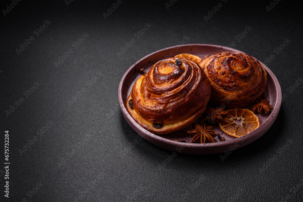 Delicious baked cinnamon raisin rolls in the form of rolls Delicious baked cinnamon raisin rolls in the form of rolls