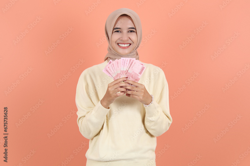 holding cash money in Indonesian rupiah banknotes holding cash money in Indonesian rupiah banknotes