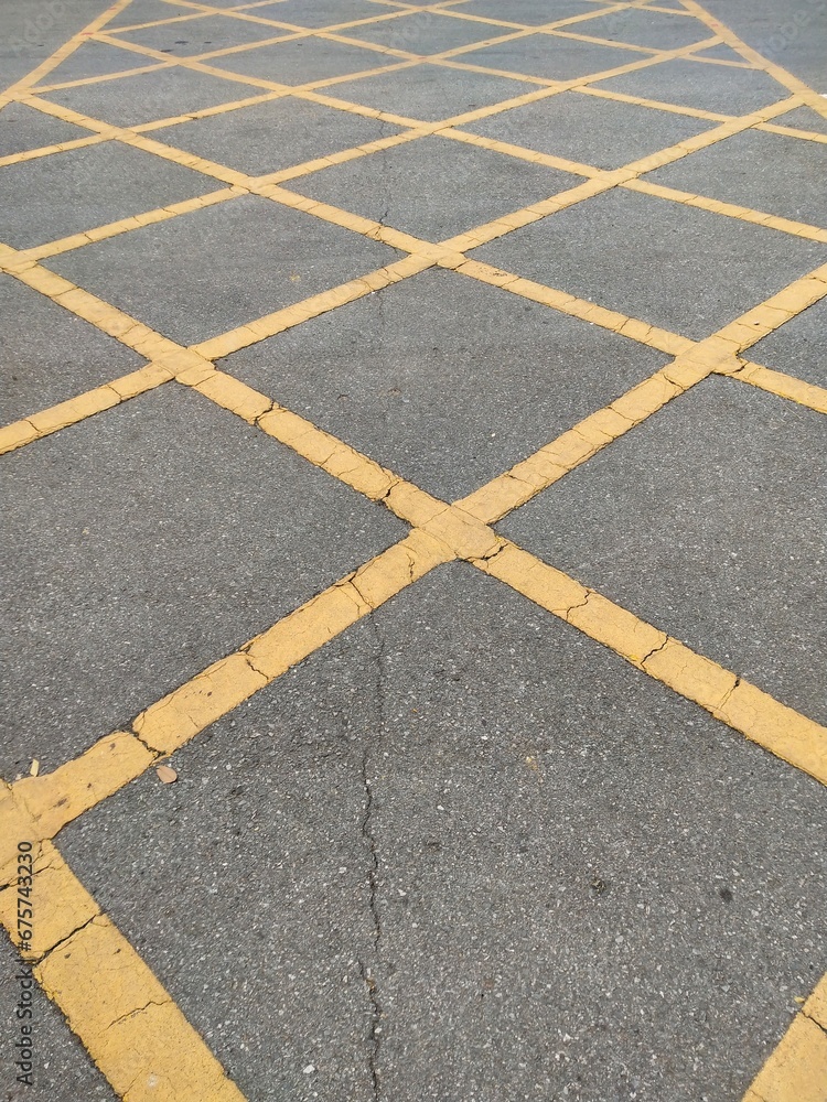 Yellow traffic lines on asphalt surface