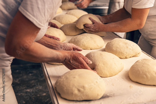Cuadro en lienzo Bakers forming bread dough in a bakery