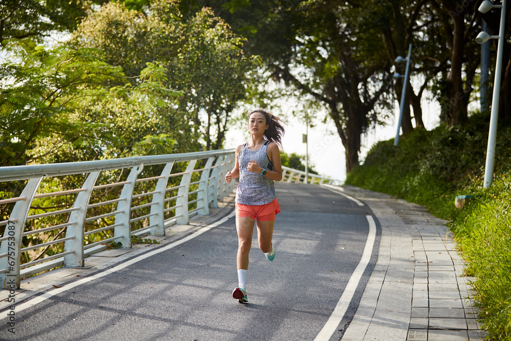 young asian woman jogging running exercising outdoors in park young asian woman jogging running exercising outdoors in park