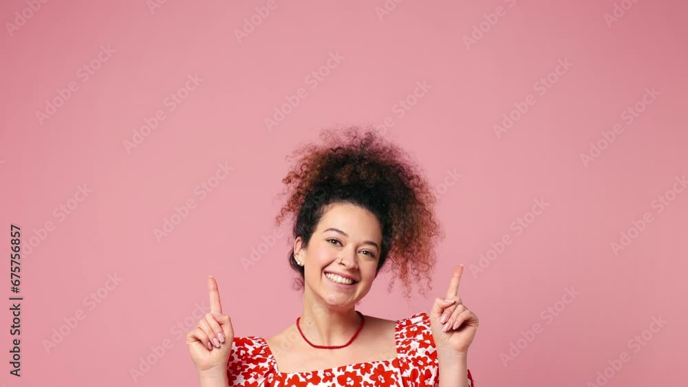 Young latin woman wear red casual clothes pointing indicate index finger overhead on workspace area copy space mock up isolated on pastel plain light pink background studio portrait. Lifestyle concept Young latin woman wear red casual clothes pointing indicate index finger overhead on workspace area copy space mock up isolated on pastel plain light pink background studio portrait. Lifestyle concept