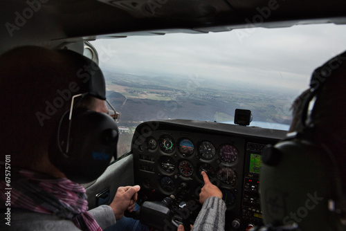 view from over snow covered peaks while flying in small plane photo