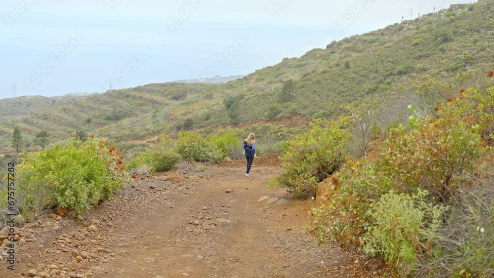 Young woman traveler in majestic landscape of Tenerife mountains Young woman traveler in majestic landscape of Tenerife mountains