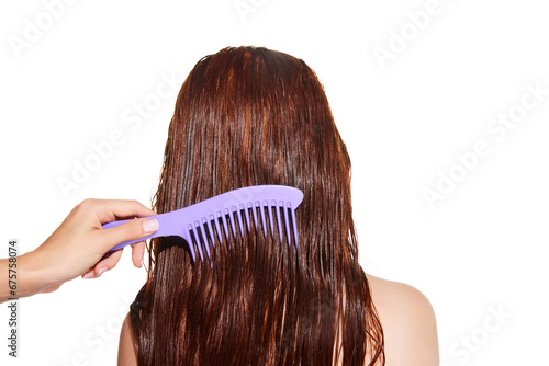 Female hand brushing long wet hair of a girl against white studio background. Taking care after hair look, mask. Concept of beauty, hair care, treatment, natural cosmetics. Copy space for ad