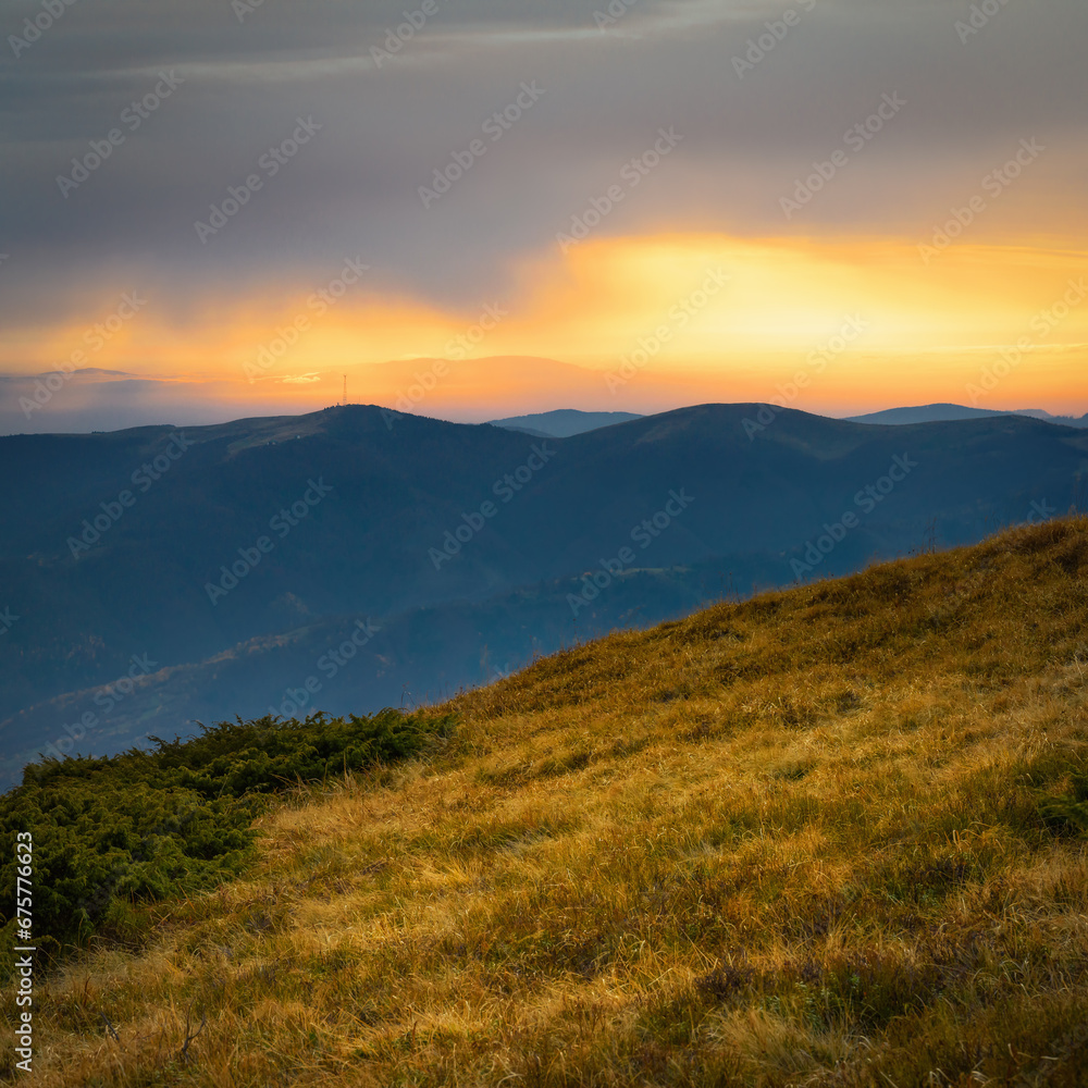 Sunset over the mountains. Calm evening landscape in the mountains with a beautiful sky. Photo wallpaper. Natural background. Panorama. Carpathian Mountains, Ukraine