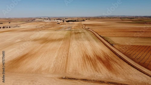 Aerial view of dry fields. Drone footage in Castilla la Mancha, land of don quijote, vineyards, flat land, cereals, dirt tracks and paths. Horcajo de Santiago in 4K with DJI Mini 2 photo