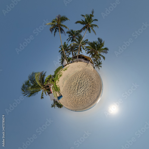 coconut trees in jungle in Indian tropic village on sea shore on little planet in blue sky, transformation of spherical 360 panorama. Spherical abstract view with curvature of space. photo