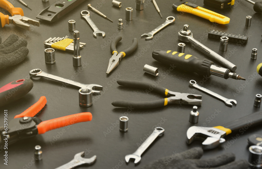 Handyman tool kit on black wooden table. Many wrenches and screwdrivers, pilers and other tools for any types of repair or construction works. Repairman tools set Handyman tool kit on black wooden table. Many wrenches and screwdrivers, pilers and other tools for any types of repair or construction works. Repairman tools set