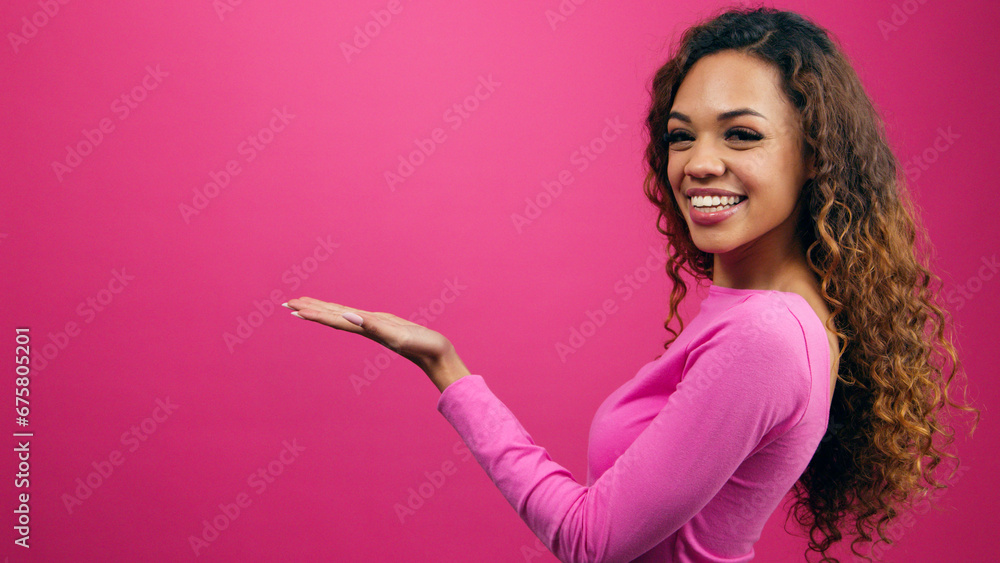 Smiling young women gestures palms to copy space, Valentine's Day promotion Smiling young women gestures palms to copy space, Valentine's Day promotion