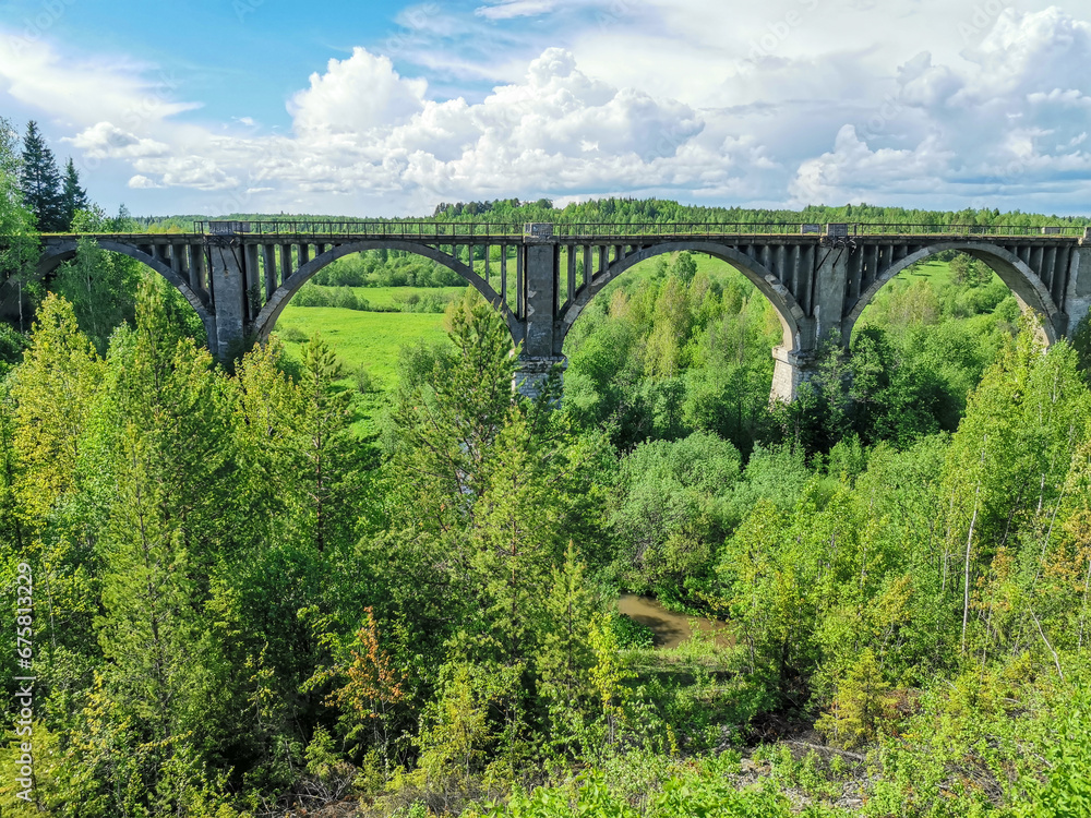 Railway bridge across the river in the south of the Kama region. The old Big Sars viaduct. The abandoned Oktyabrsky viaduct in the Perm Region. Russia. Railway bridge across the river in the south of the Kama region. The old Big Sars viaduct. The abandoned Oktyabrsky viaduct in the Perm Region. Russia.