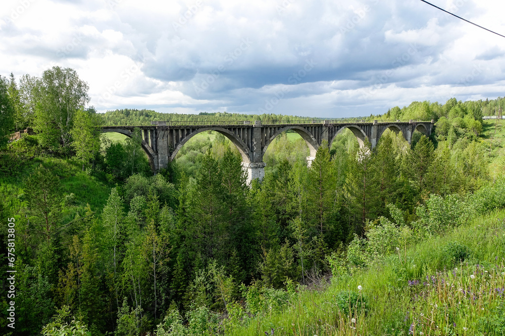 Railway bridge across the river in the south of the Kama region. The old Big Sars viaduct. The abandoned Oktyabrsky viaduct in the Perm Region. Russia. Railway bridge across the river in the south of the Kama region. The old Big Sars viaduct. The abandoned Oktyabrsky viaduct in the Perm Region. Russia.