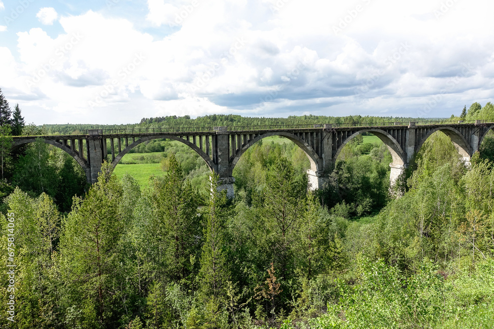 Railway bridge across the river in the south of the Kama region. The old Big Sars viaduct. The abandoned Oktyabrsky viaduct in the Perm Region. Russia. Railway bridge across the river in the south of the Kama region. The old Big Sars viaduct. The abandoned Oktyabrsky viaduct in the Perm Region. Russia.