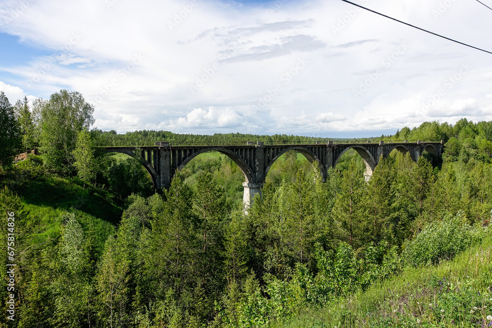 Railway bridge across the river in the south of the Kama region. The old Big Sars viaduct. The abandoned Oktyabrsky viaduct in the Perm Region. Russia. Railway bridge across the river in the south of the Kama region. The old Big Sars viaduct. The abandoned Oktyabrsky viaduct in the Perm Region. Russia.