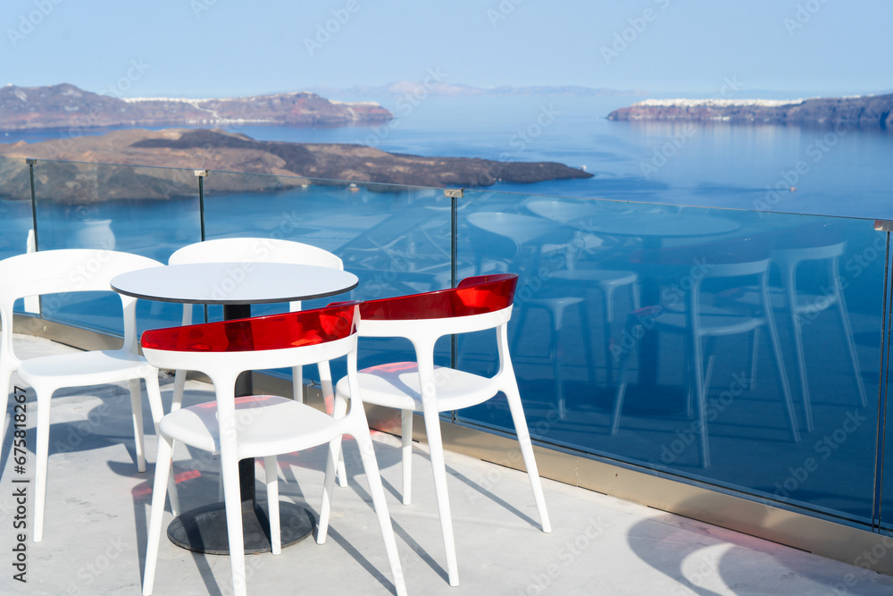 Fototapeta premium cafe table with caldera view, juice and greek yogurt on the table near sea